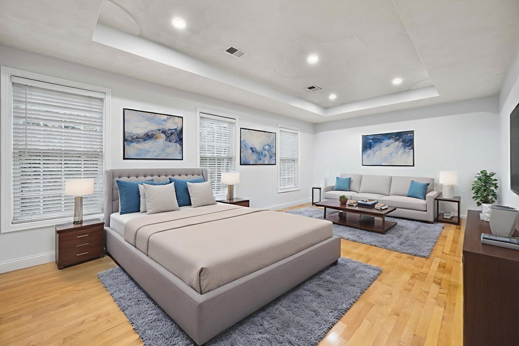 772 Main Street, Unit 2 Wakefield, MA 01880 - Photo 13 of 30 a bedroom with a large bed and a couch