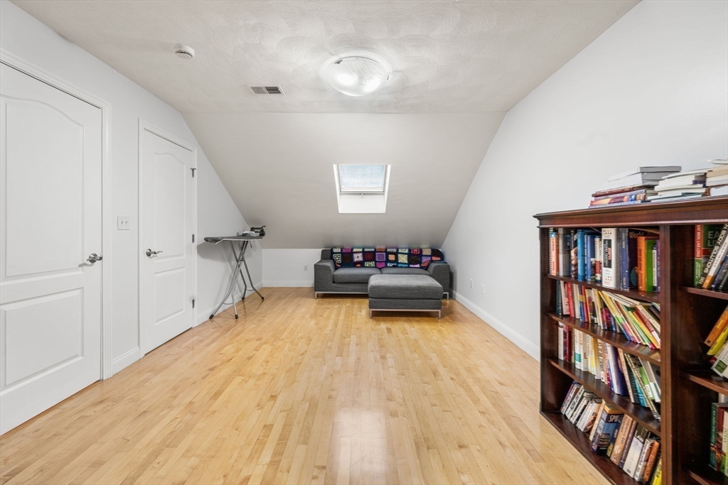 772 Main Street, Unit 2 Wakefield, MA 01880 - Photo 21 of 30 a bedroom with furniture and a book shelf