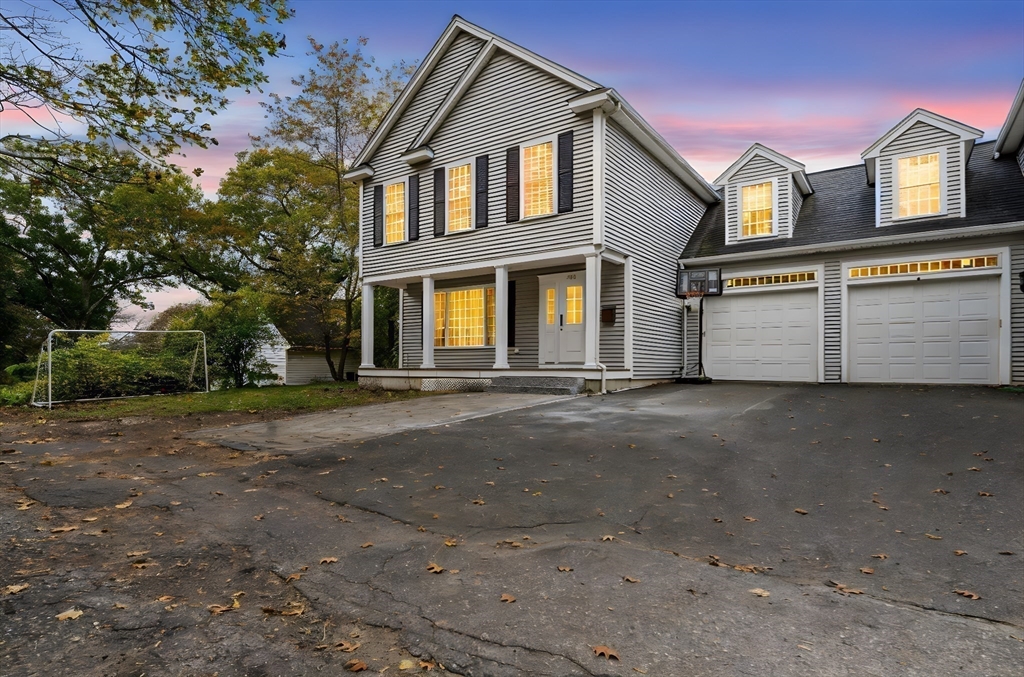 772 Main Street, Unit 2 Wakefield, MA 01880 - Photo 3 of 30 a front view of a house with a yard and garage