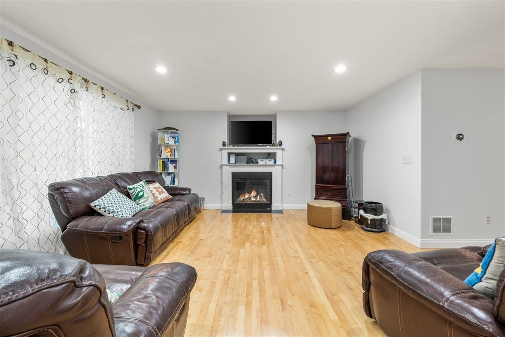 772 Main Street, Unit 2 Wakefield, MA 01880 - Photo 5 of 30 a living room with furniture fireplace and a flat screen tv