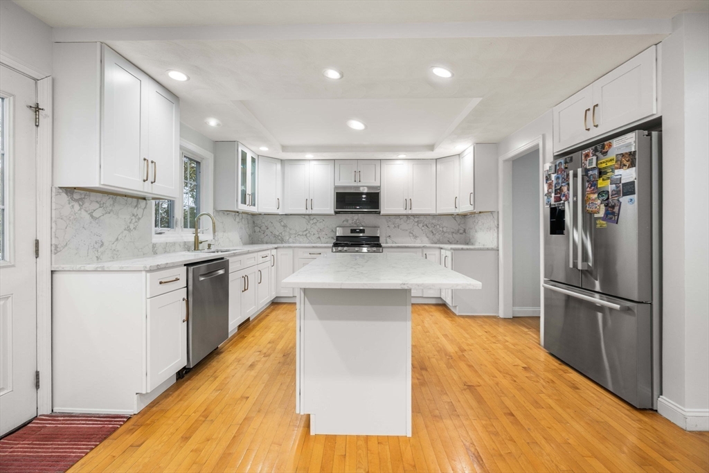 772 Main Street, Unit 2 Wakefield, MA 01880 - Photo 8 of 30 a large kitchen with stainless steel appliances granite countertop a sink a stove a refrigerator and cabinets