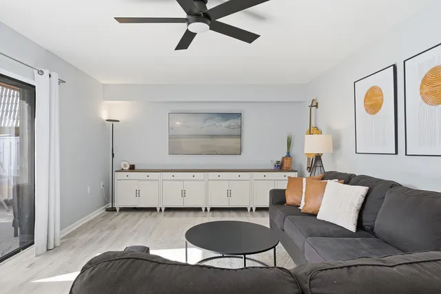 a living room with furniture and a wooden floor