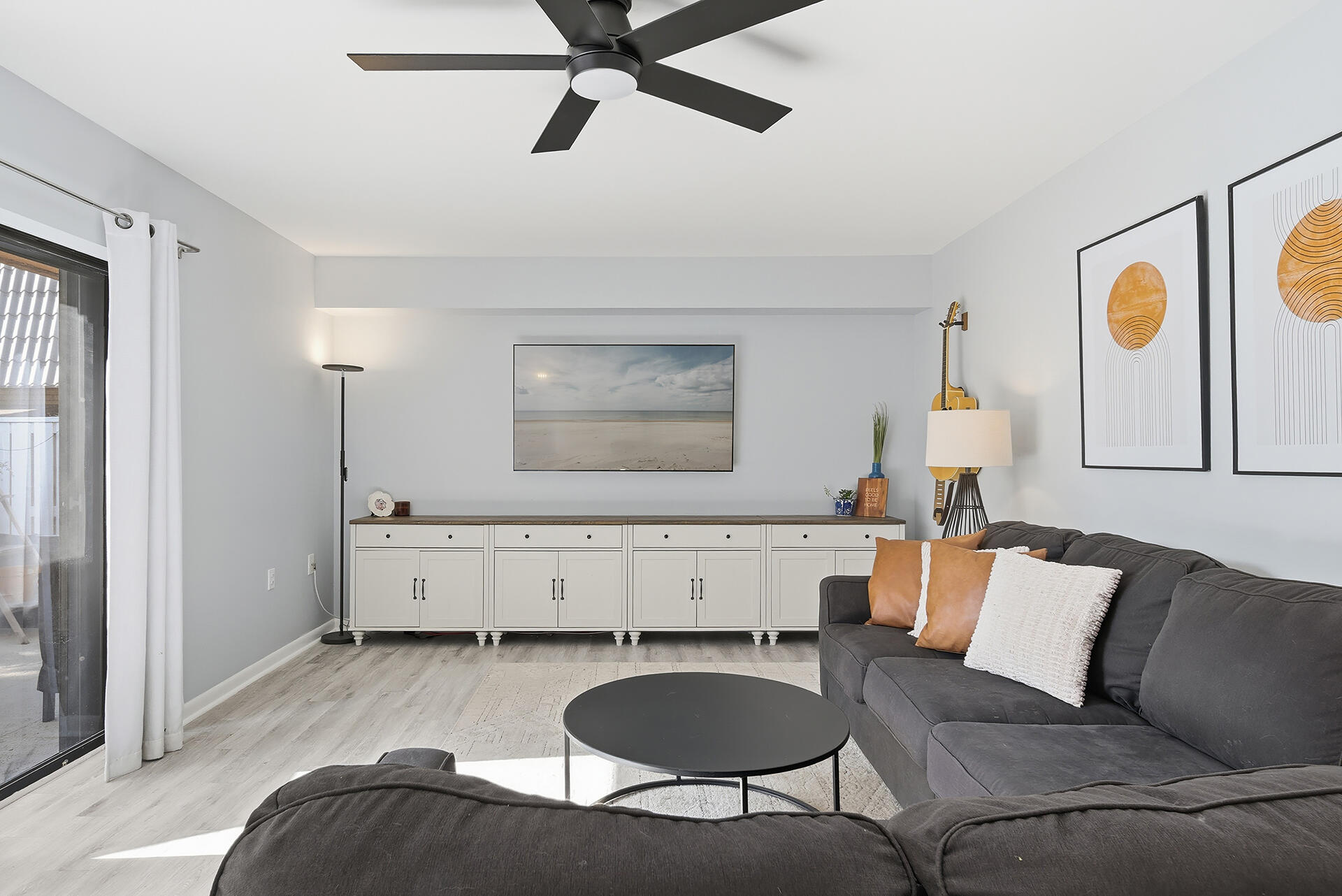 a living room with furniture and a wooden floor