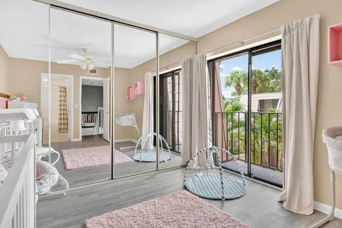 a living room with hardwood floor and a large window