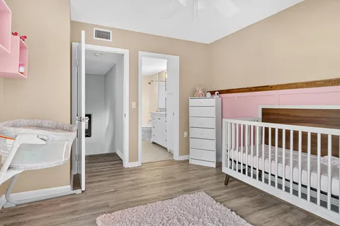 a view of a hallway with wooden floor and entryway