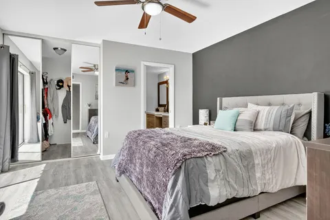 a spacious bedroom with a bed and a dresser