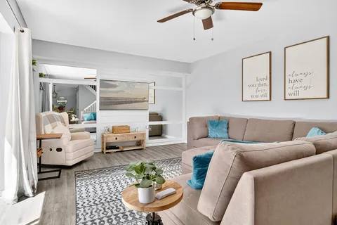 a living room with furniture and a fireplace