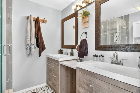 a bathroom with a sink vanity and a mirror