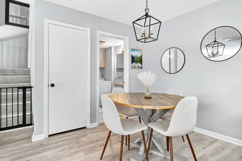 a view of a dining room with furniture wooden floor and a chandelier
