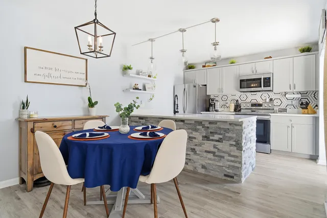 a bedroom with a bed a couch and large window