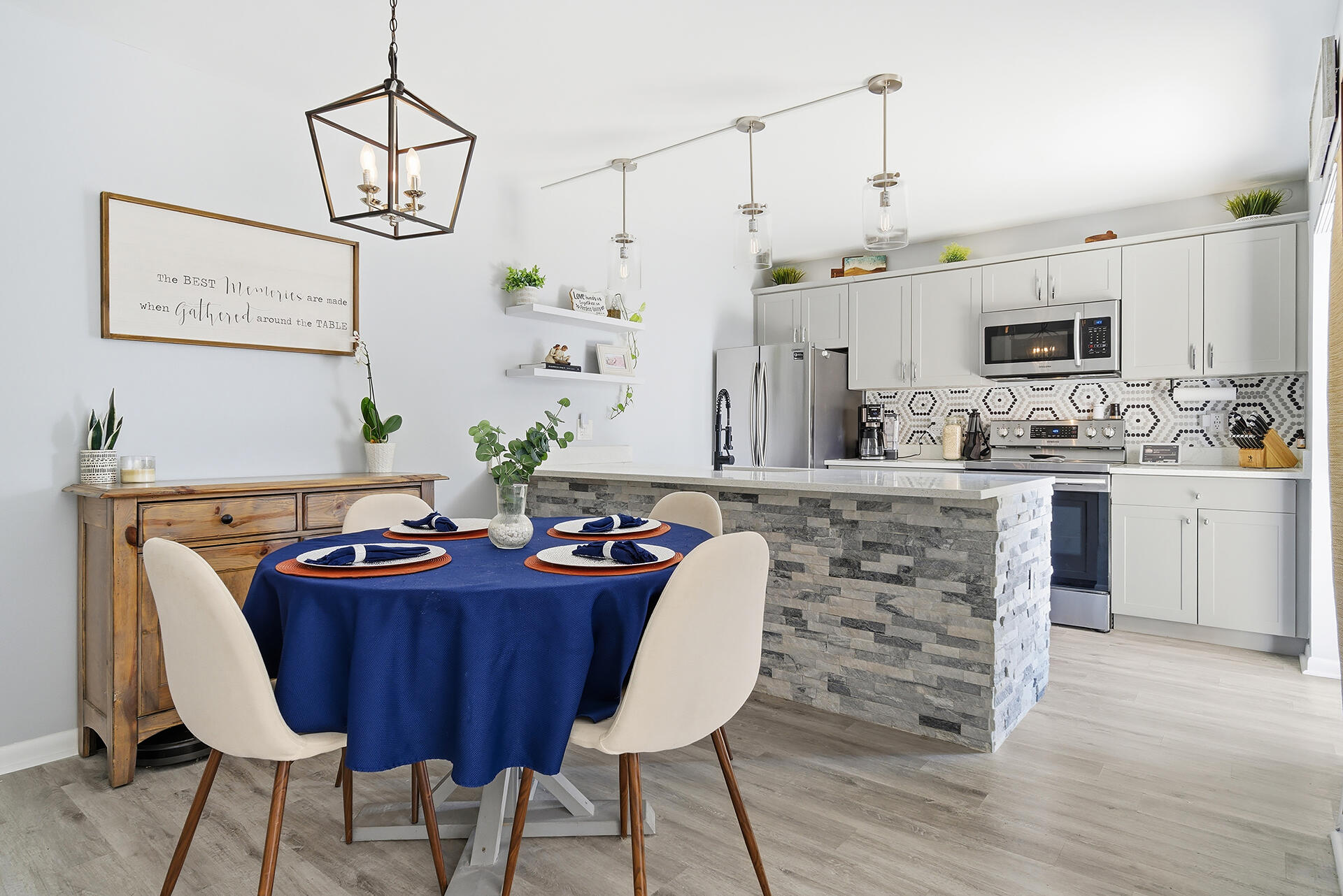 6818 68th Way West Palm Beach, FL 33409 - Photo 5 of 31 a kitchen with stainless steel appliances kitchen island a table and chairs in it