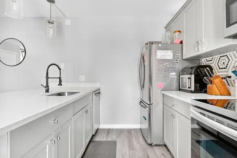 a kitchen with stainless steel appliances granite countertop a sink and cabinets