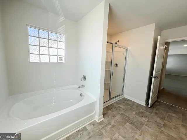 a bathroom with a bathtub and a shower