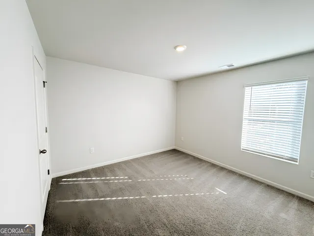 an empty room with a empty space and window