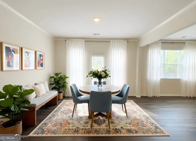 a dining room with furniture and wooden floor