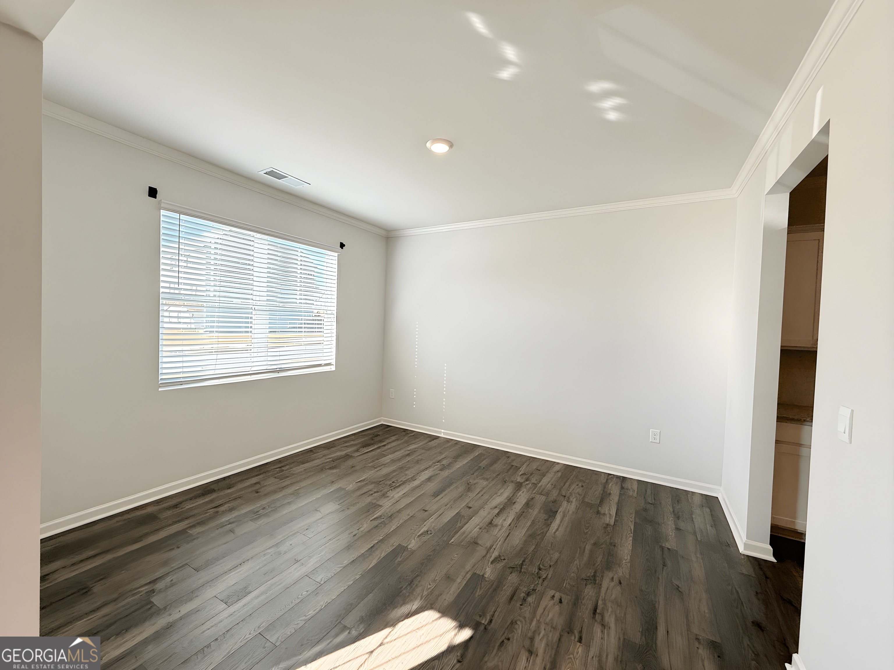 622 Brookfield Drive Braselton, GA 30517 - Photo 5 of 34 a view of an empty room with wooden floor and a window