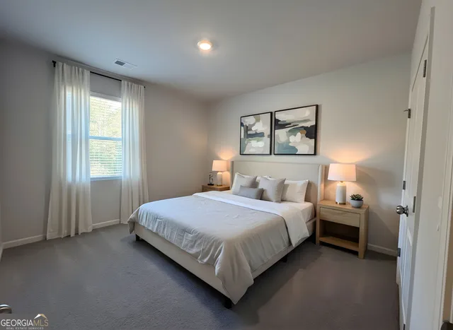 a bedroom with a bed and a window