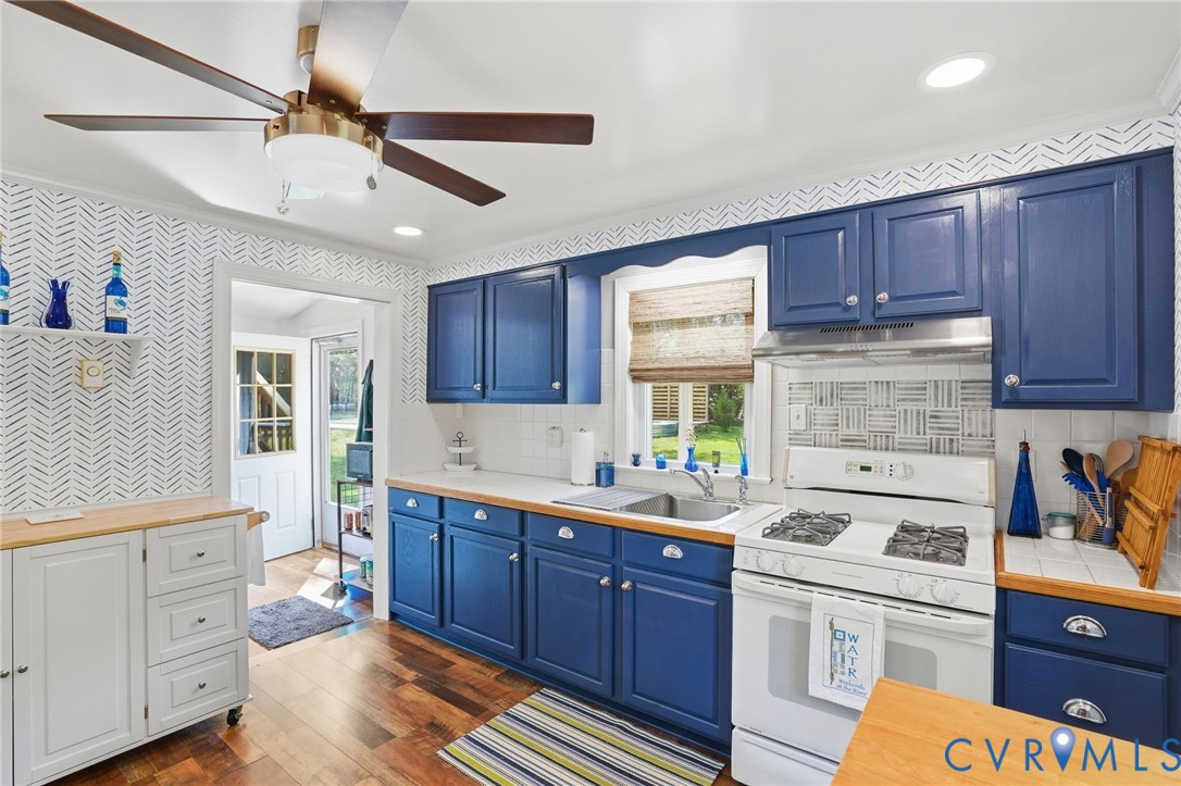247 Salisbury Park Road Hague, VA 22469 - Photo 11 of 44 a kitchen with a sink a stove cabinets and a window