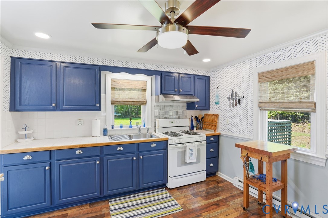 247 Salisbury Park Road Hague, VA 22469 - Photo 12 of 44 a kitchen with a sink a window cabinets and stainless steel appliances