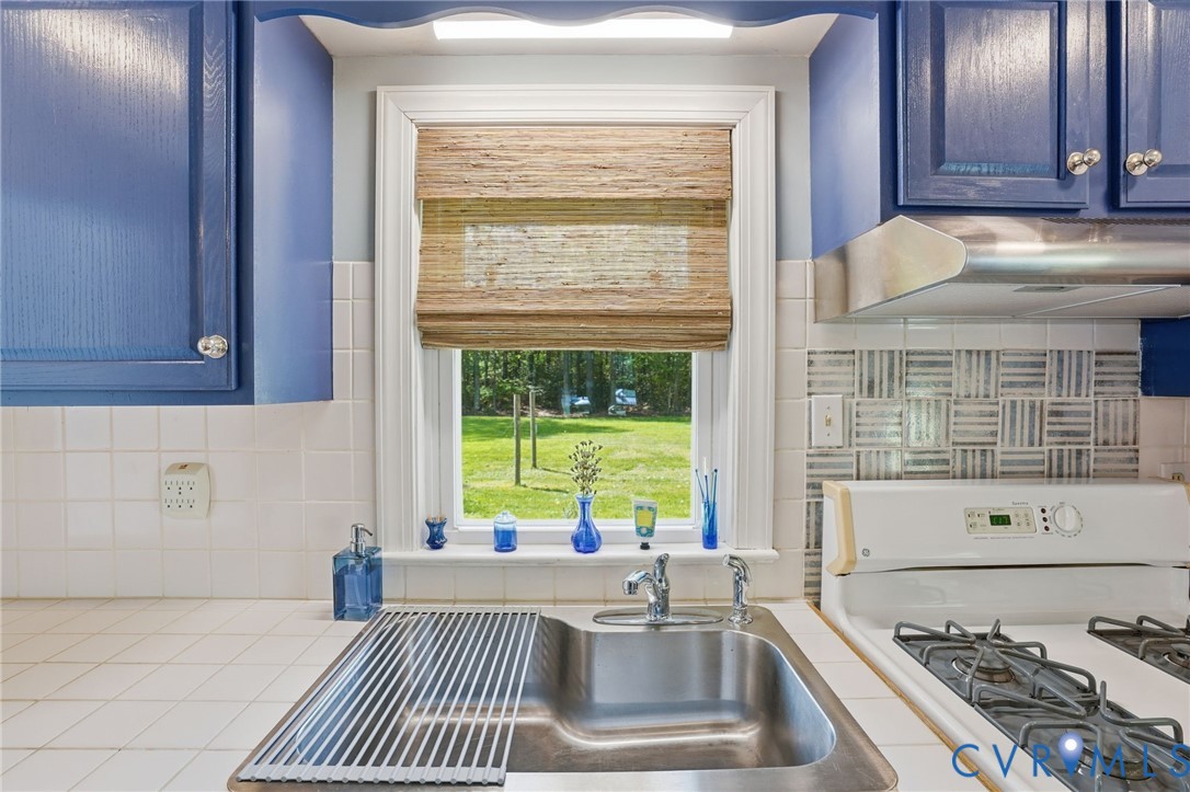 247 Salisbury Park Road Hague, VA 22469 - Photo 13 of 44 a kitchen with a sink a stove and a window
