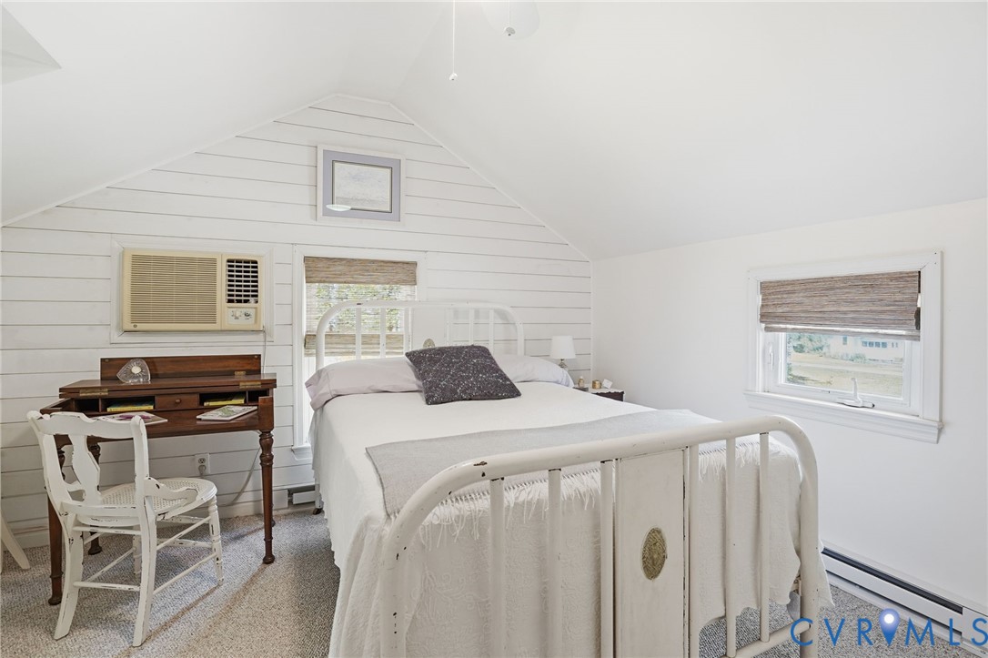 247 Salisbury Park Road Hague, VA 22469 - Photo 28 of 44 a bedroom with a bed and a chair in it