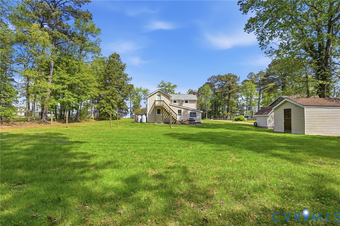 247 Salisbury Park Road Hague, VA 22469 - Photo 40 of 44 a view of a white house with a big yard and large trees