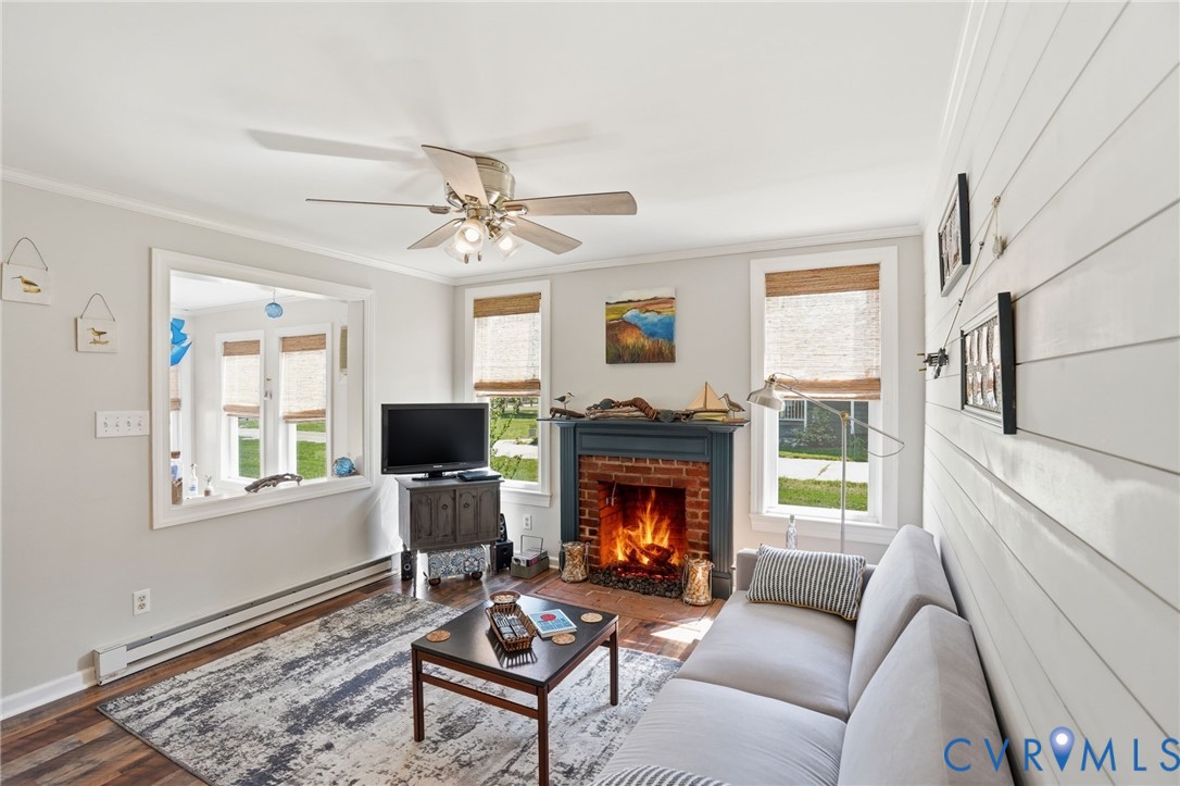 247 Salisbury Park Road Hague, VA 22469 - Photo 6 of 44 a living room with furniture a flat screen tv and a fireplace