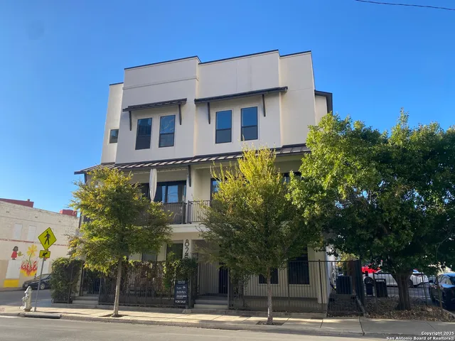 a view of a tall building next to a road