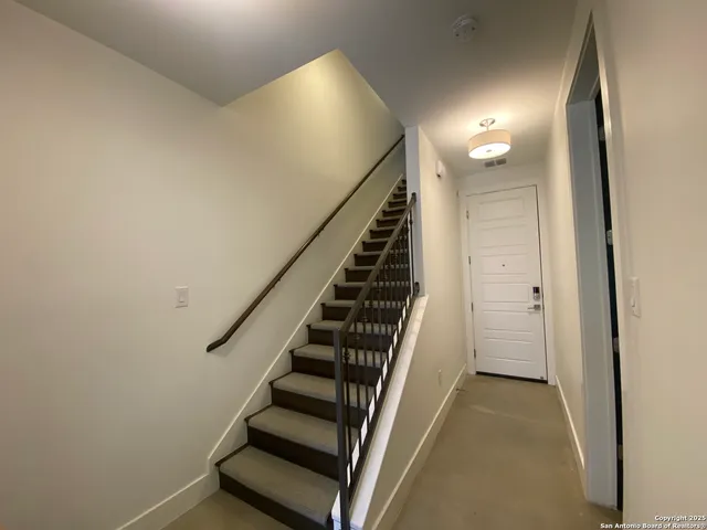 a view of entryway and gallery with wooden floor