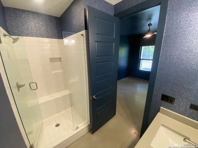 a bathroom with a bathtub and shower