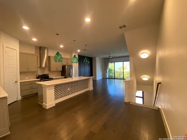 a large white kitchen with a large window