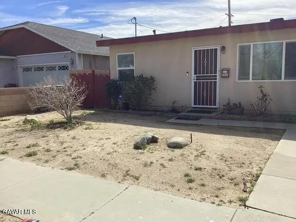 a view of a house with snow on the road