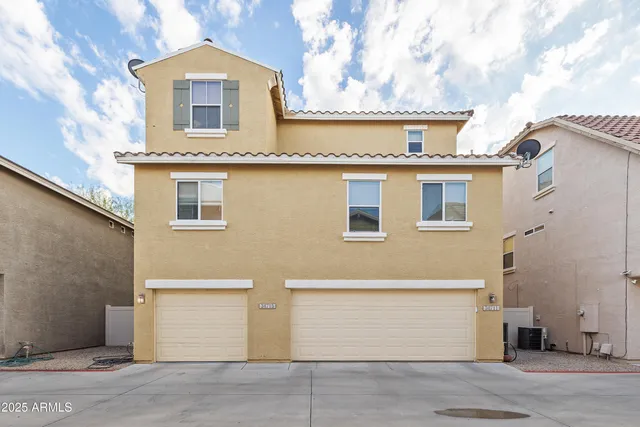 a front view of a house with a parking area
