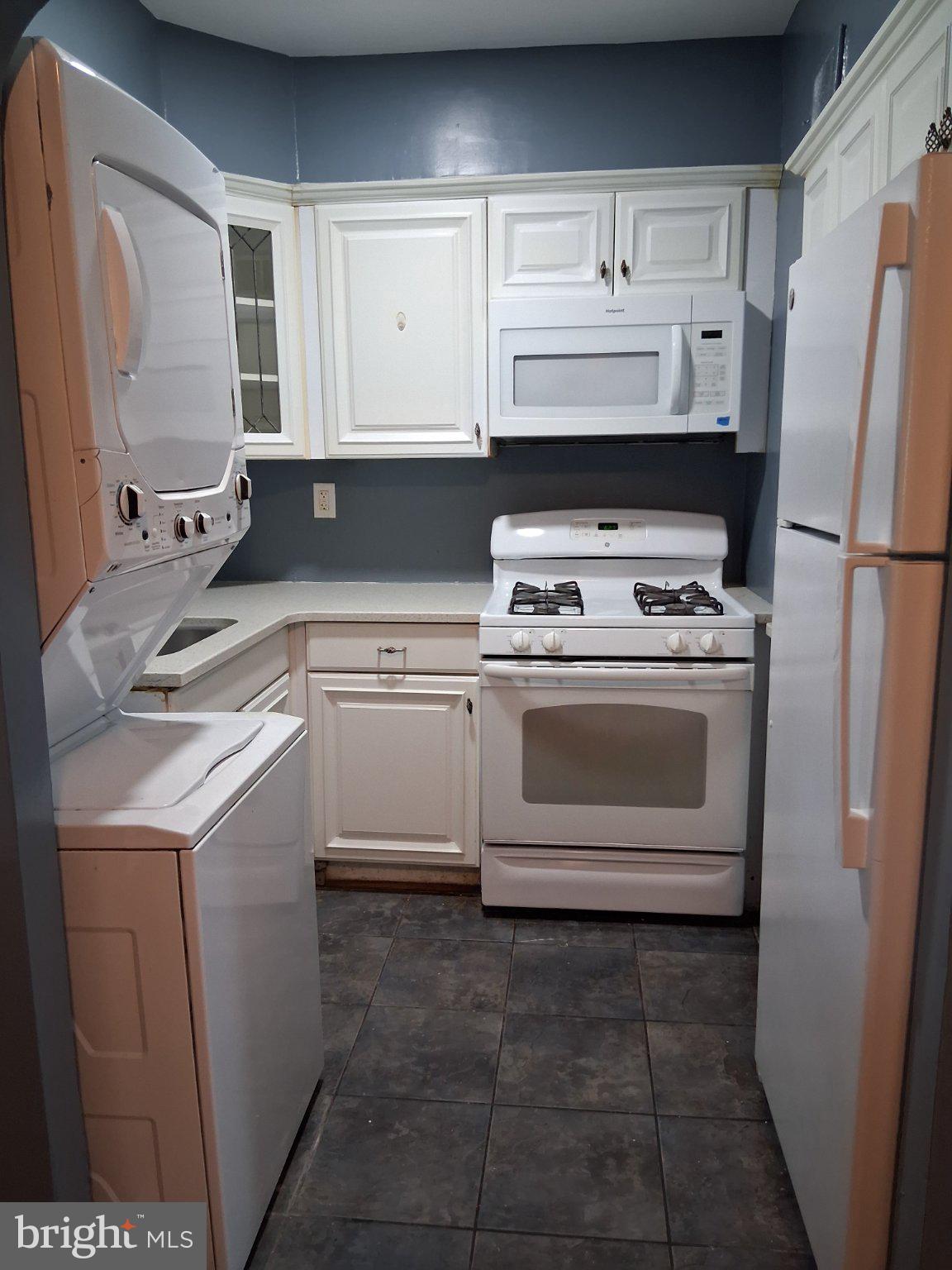 1143 19th Street Northeast Washington, DC 20002 - Photo 4 of 13 a kitchen with a stove sink and refrigerator