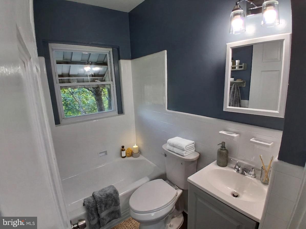 1143 19th Street Northeast Washington, DC 20002 - Photo 7 of 13 a bathroom with a sink mirror and toilet