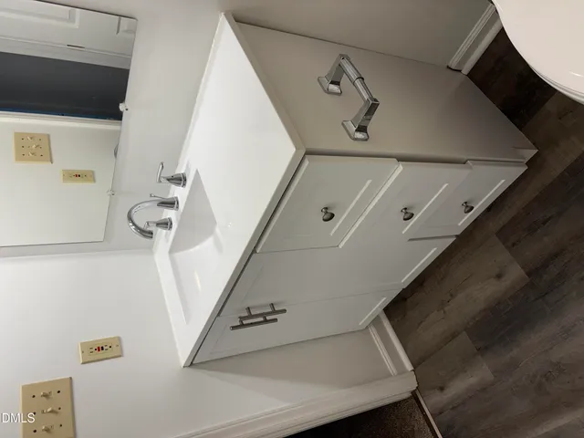 a view of staircase with railing and white walls