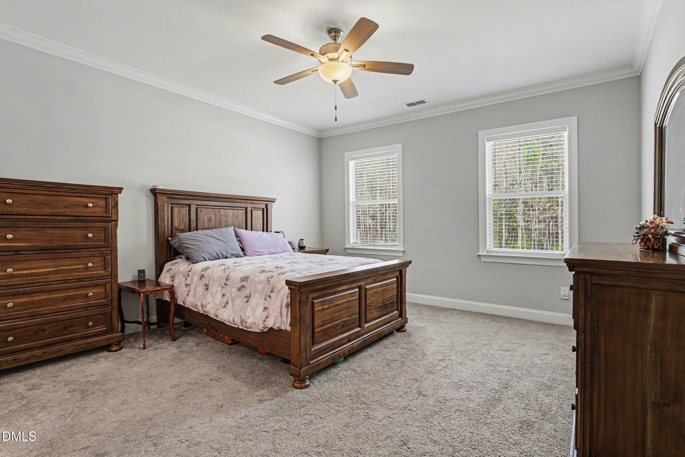130 Aylebury Ridge Zebulon, NC 27597 - Photo 23 of 41 a bed sitting in a bedroom next to a window