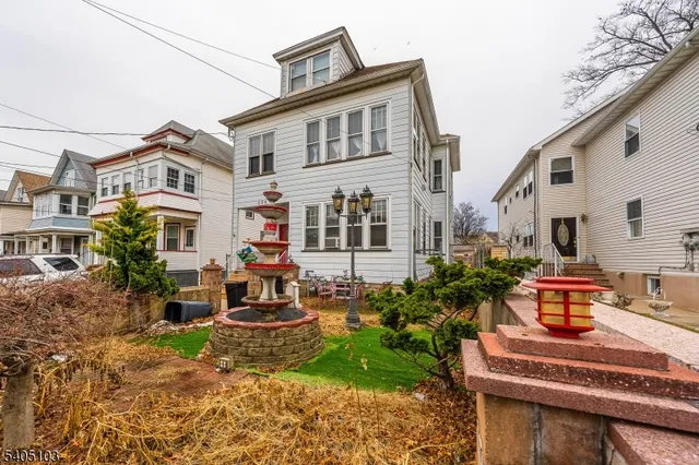 a front view of house with yard outdoor seating and barbeque oven