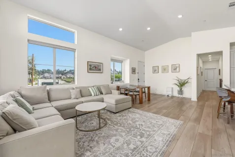 a living room with furniture wooden floor and a table