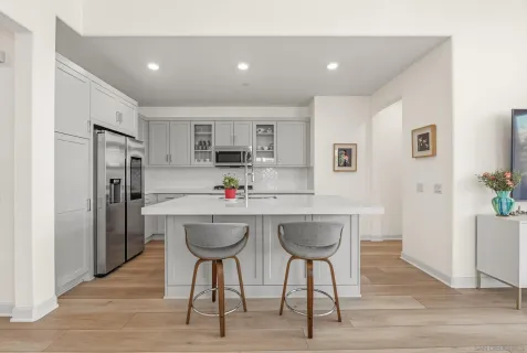 a kitchen with stainless steel appliances a sink and a refrigerator