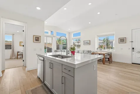 a kitchen with sink attached with living room