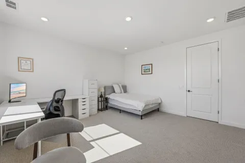 a bedroom with furniture and a window