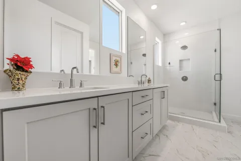 a bathroom with a shower sink and mirror