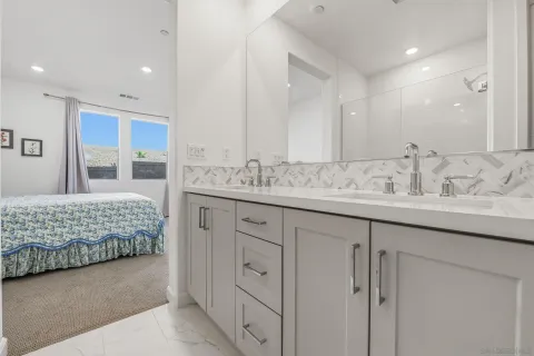 a bathroom with a double vanity sink and a mirror