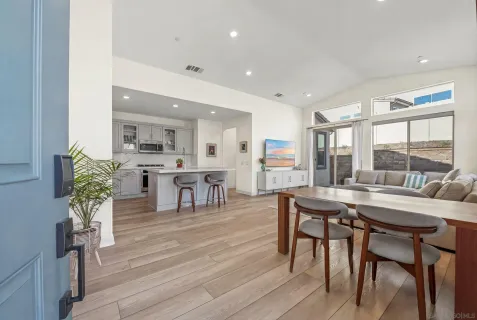a dining room with furniture and wooden floor