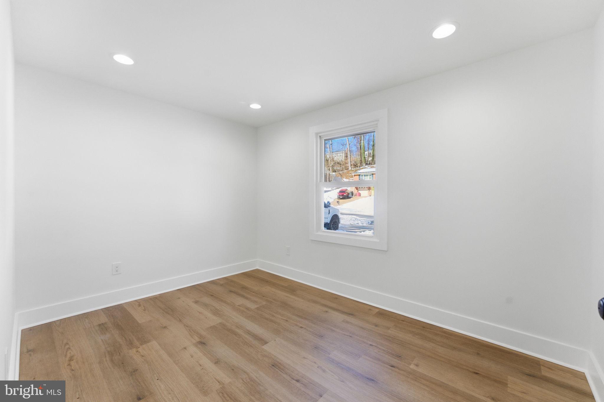 8615 Kerry Lane Springfield, VA 22152 - Photo 38 of 50 an empty room with wooden floor and window