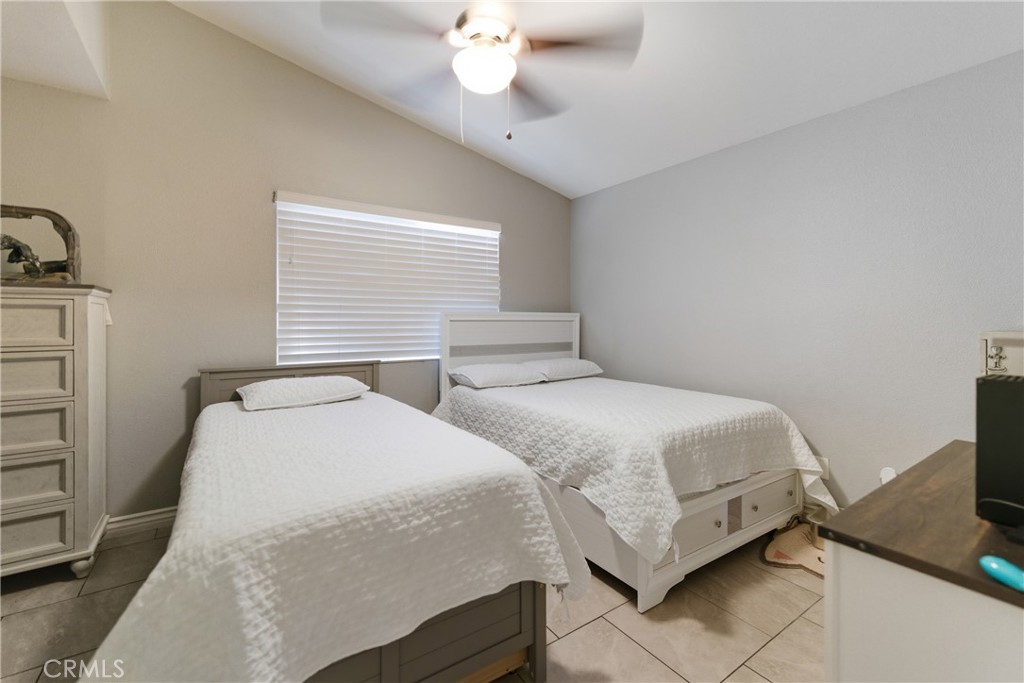 24150 Rothbury Drive Moreno Valley, CA 92553 - Photo 14 of 26 a bedroom with two beds and painted walls