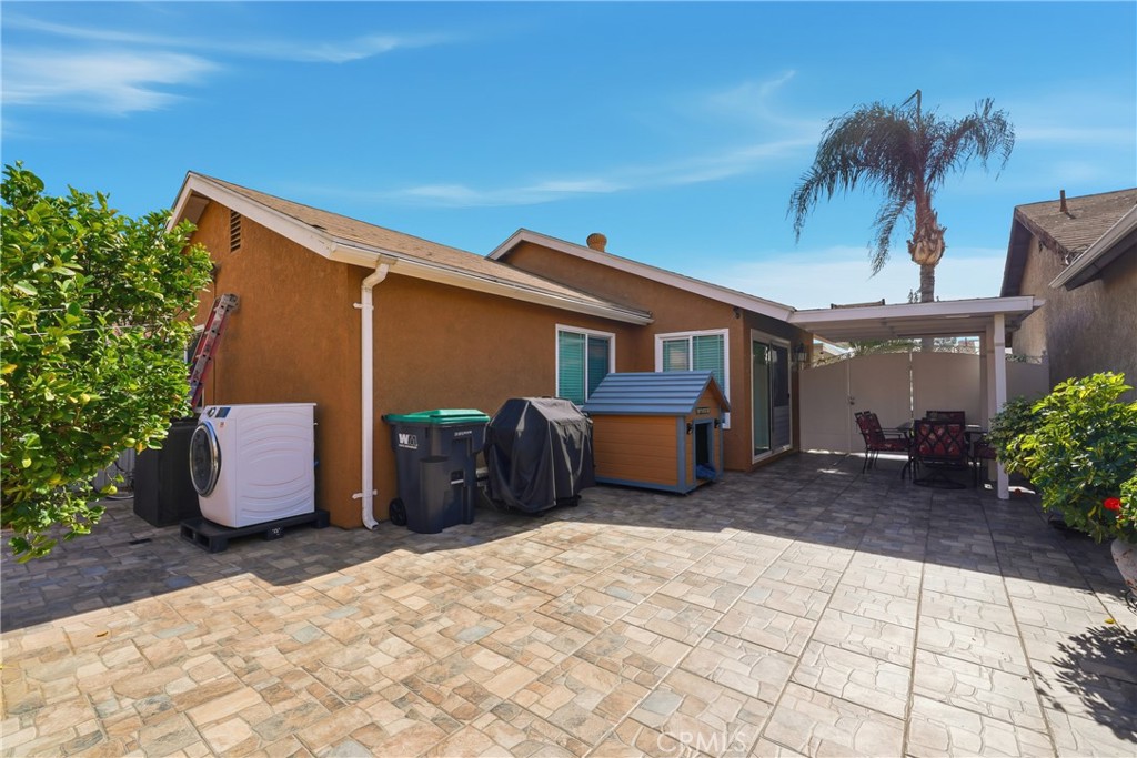 24150 Rothbury Drive Moreno Valley, CA 92553 - Photo 23 of 26 a backyard of a house with yard and outdoor seating