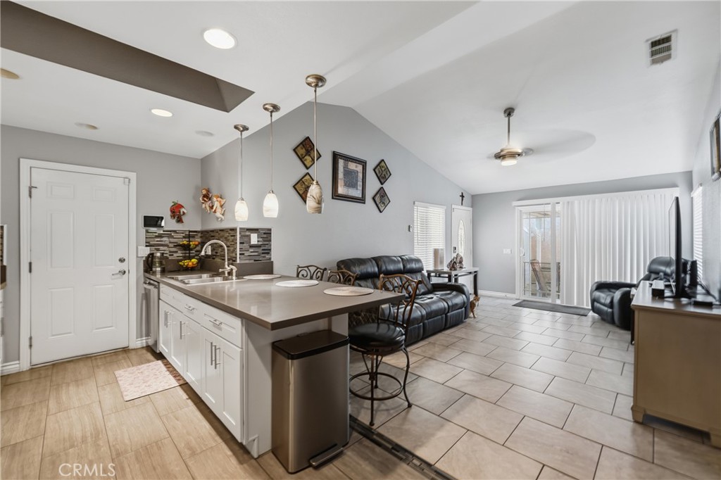 24150 Rothbury Drive Moreno Valley, CA 92553 - Photo 7 of 26 a kitchen with stainless steel appliances granite countertop a stove a sink dishwasher and a refrigerator with wooden floor