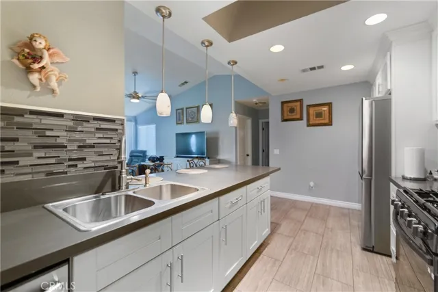 a kitchen with stainless steel appliances a sink and a refrigerator